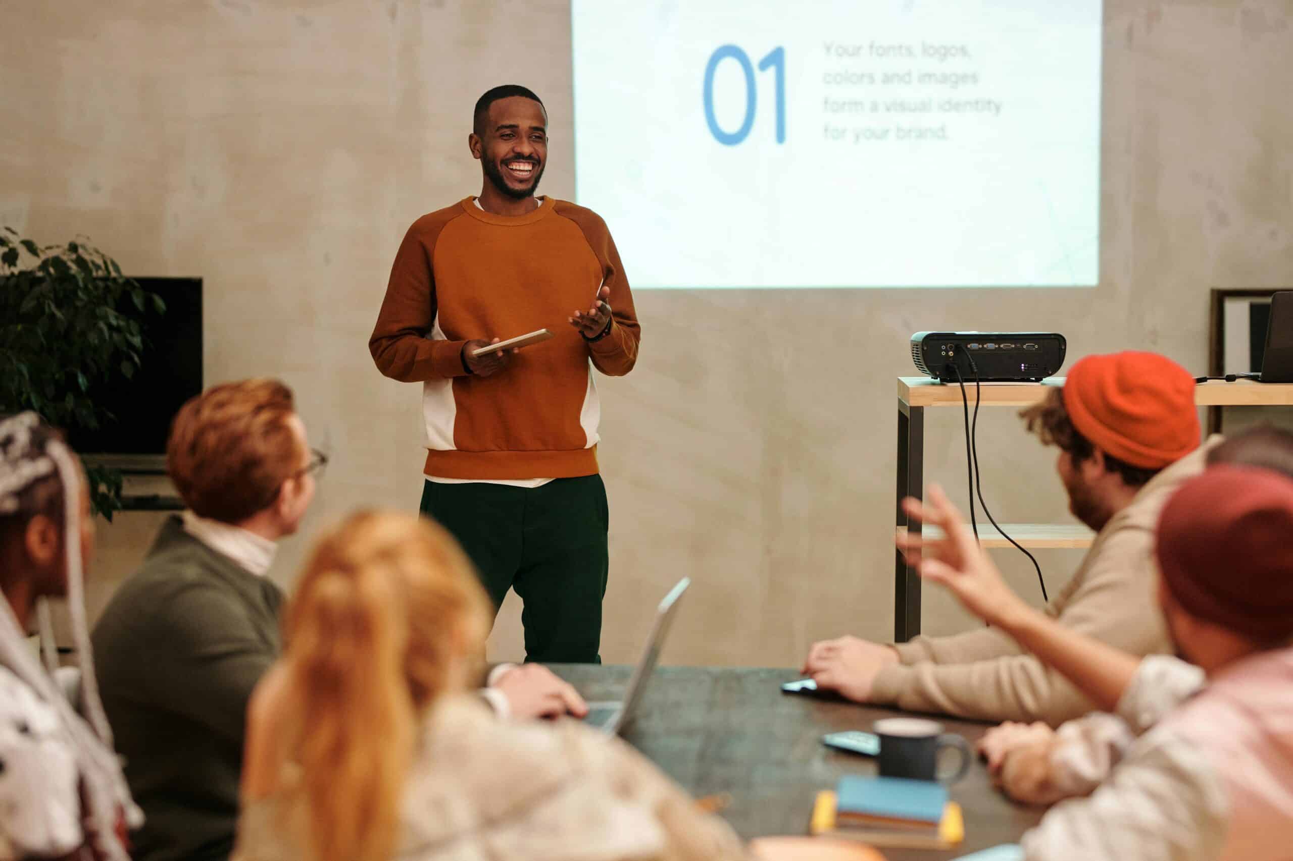 Instructor leading a counsellor workshop with a presentation slide behind them during a professional development session