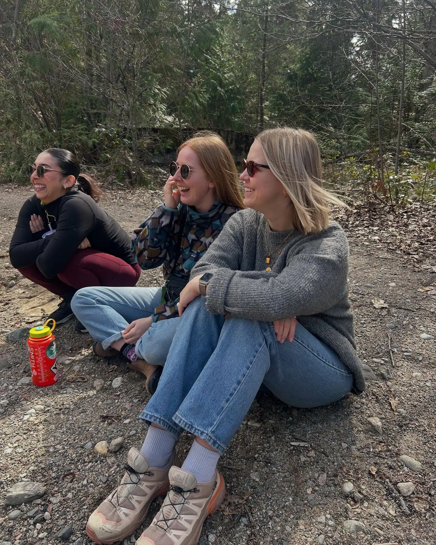 Graduate interns sitting outdoors during a community-building hike with the R.I.C. supervision cohort.