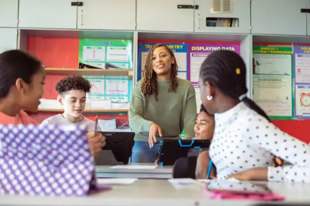 Teacher engaging students in a classroom discussion about STEM, representing lived-experience counselling for educators
