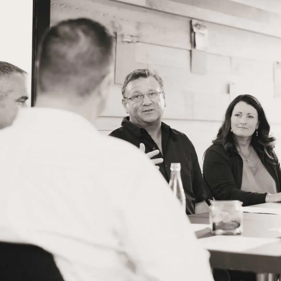 Leadership team discussing program strategy during a board meeting.