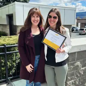 Outdoor certificate presentation for R.I.C. graduate counselling intern