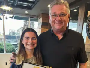 R.I.C. intern receiving certificate from supervisor during Masters program celebration