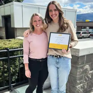 Anna Bach receiving her Graduate Student Internship Award with an R.I.C. supervisor outdoors.