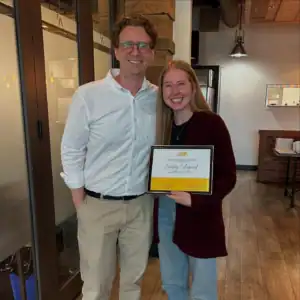 Courtney Collingwood holding her Graduate Student Internship certificate with her R.I.C. supervisor.