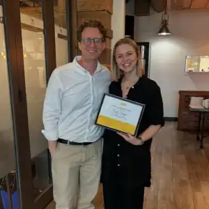 Graduate intern Emily Draper holding her internship award with her Restored Image Counselling supervisor.