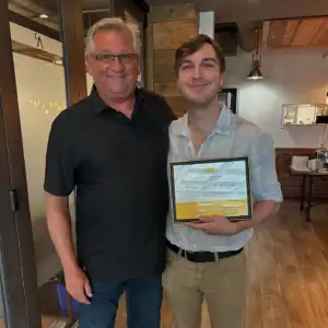 Graduate intern Maximillian von Krosigk receiving his R.I.C. Graduate Internship award.