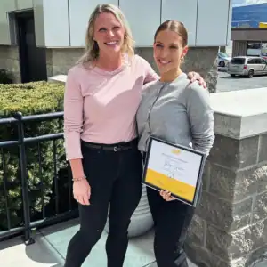 Maya Green receiving her Graduate Student Internship Award with an R.I.C. supervisor outdoors.