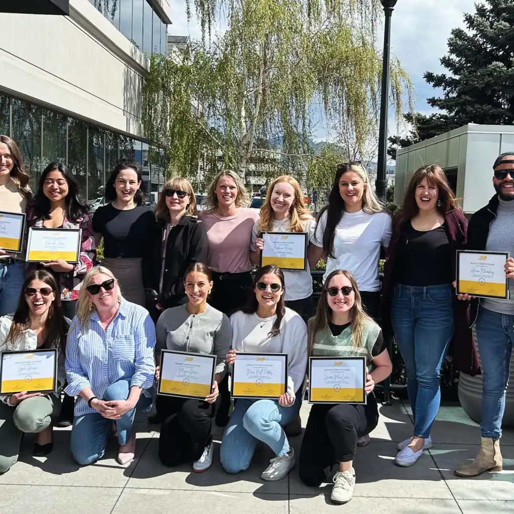 Group of Masters counselling interns holding certificates at Restored Image Counselling’s graduation ceremony.