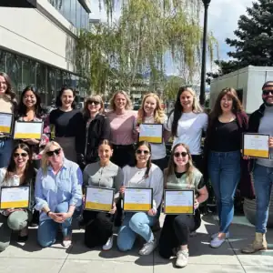 Group of Masters counselling interns holding certificates at Restored Image Counselling’s graduation ceremony.