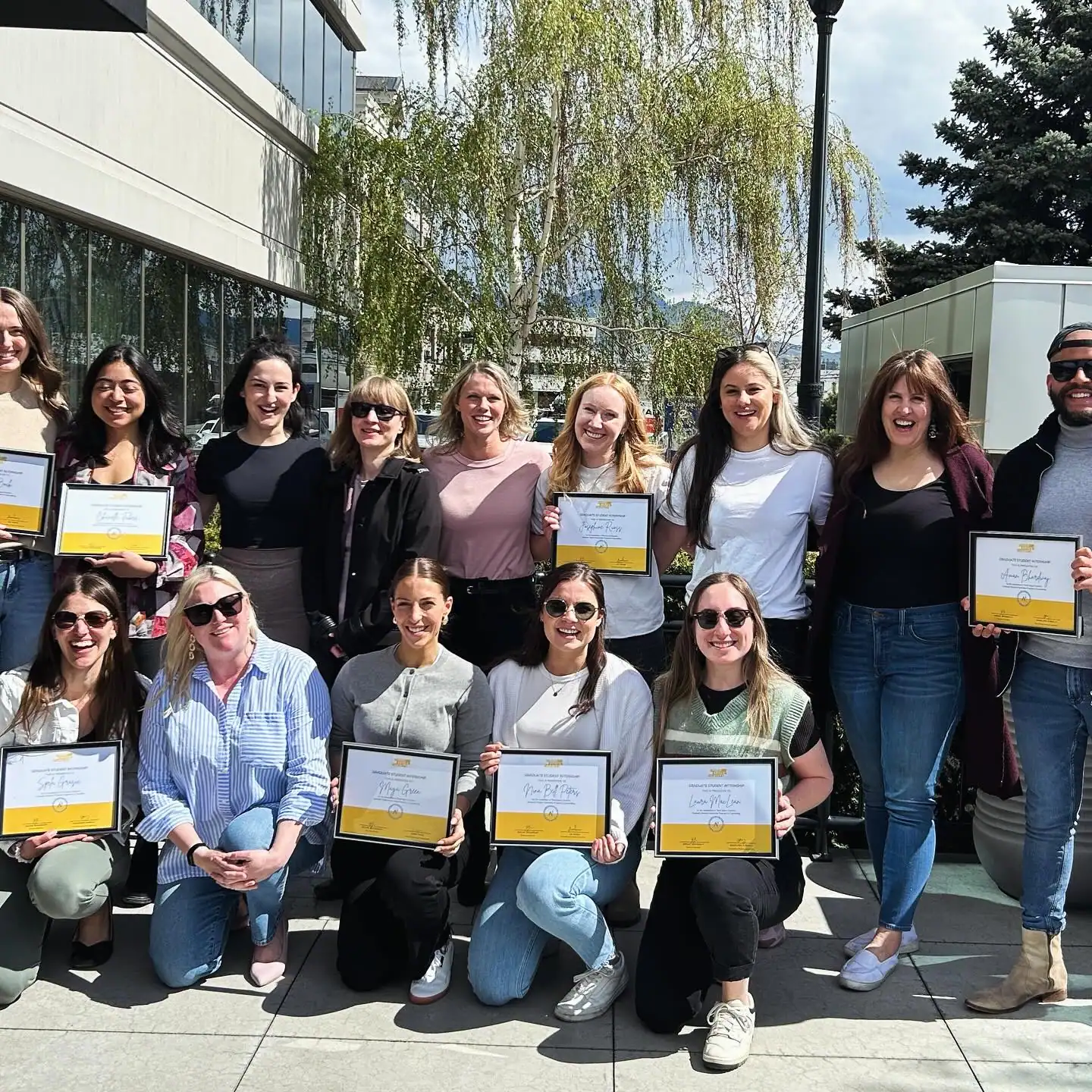 Group of Masters counselling interns holding certificates at Restored Image Counselling’s graduation ceremony.
