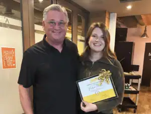 Supervisor awarding graduate internship certificate to Madison Johnson at R.I.C.