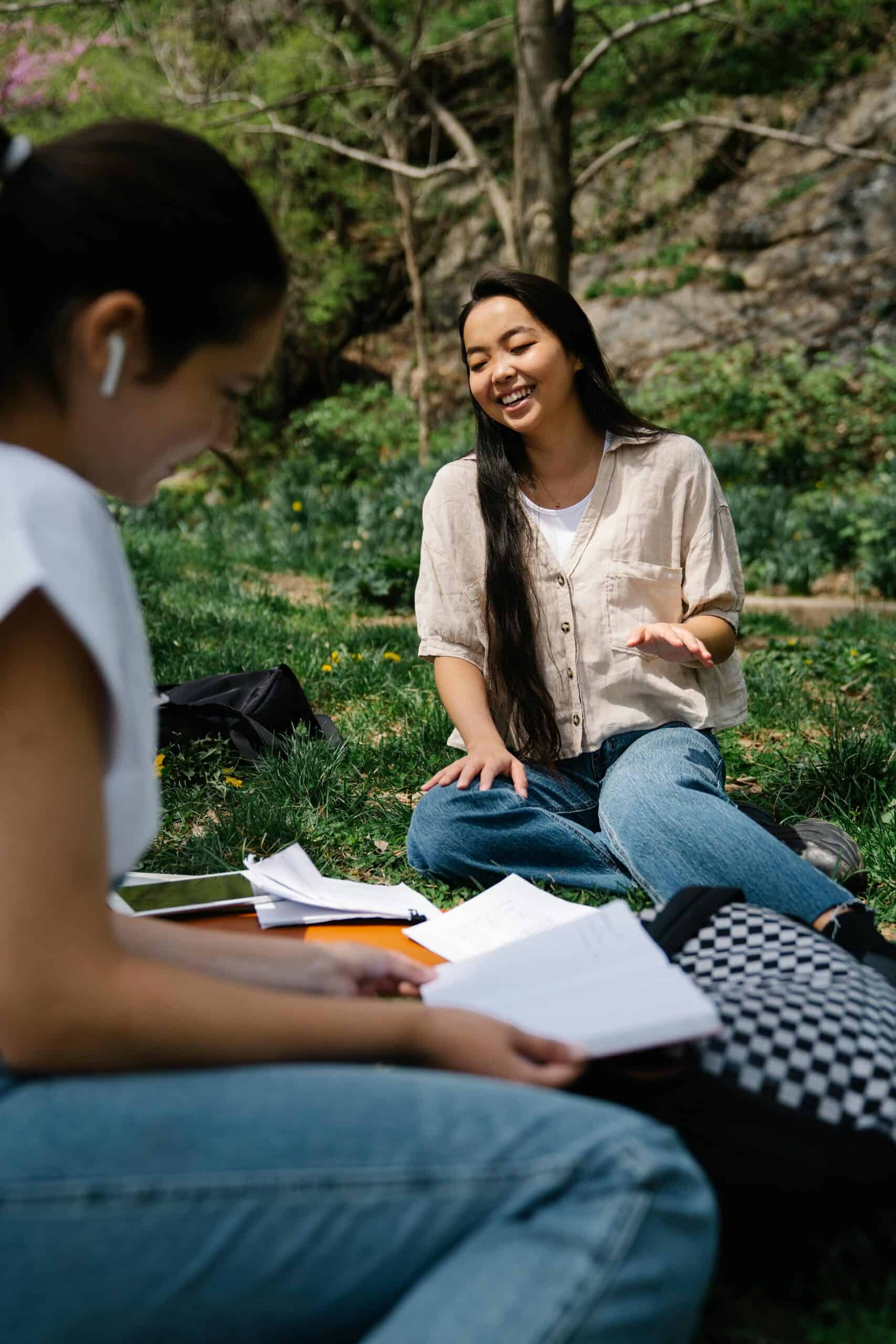 University students studying together outdoors and smiling